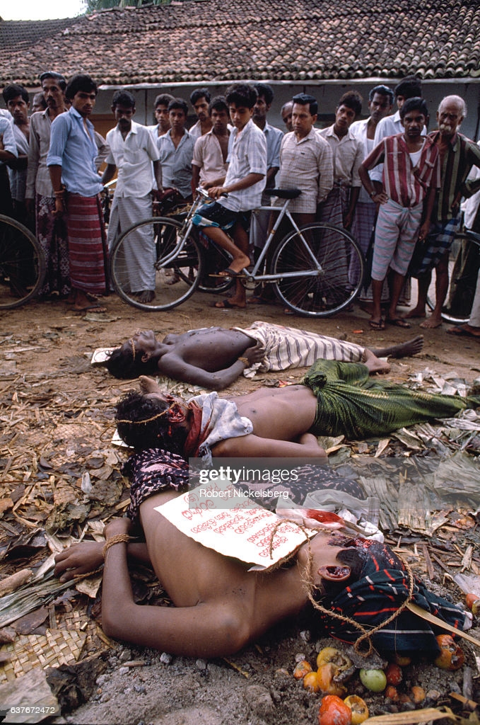 TIHAGODA, SRI LANKA - DECEMBER 2: Victims of an anti-JVP death squad attack December 2, 1989 lie in an intersection in Tihagoda, Sri Lanka. The men were picked up for interrogation during the JVP insurrection, a Buddhist-Sinhalese Marxist organization. (Photo by Robert Nickelsberg/Getty Images)